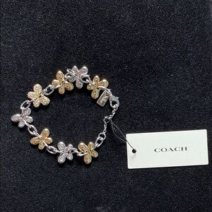 Coach Two-Tone Floral Charm Bracelet in Gold and Silver